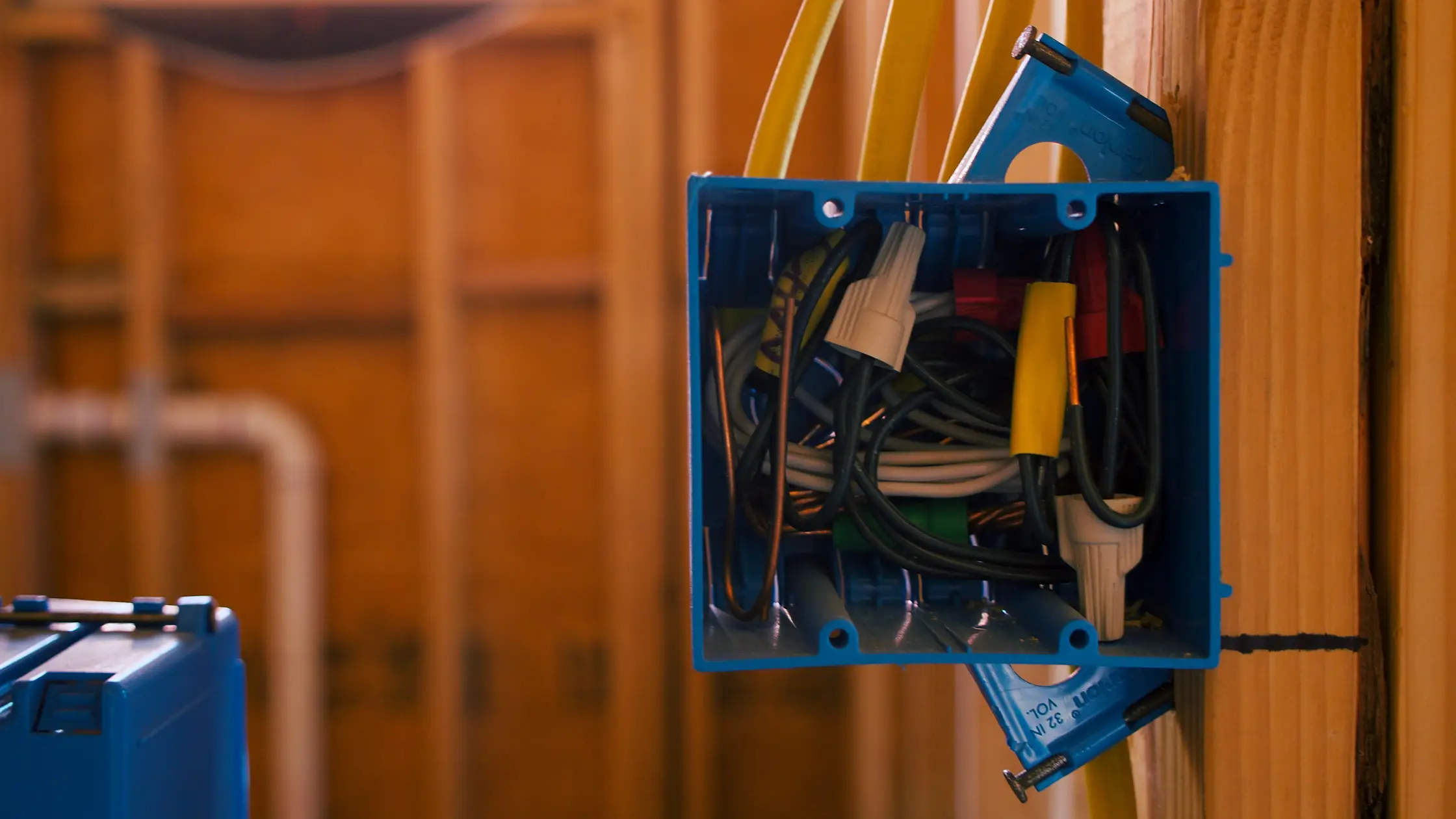 Electrical junction box with wires in wall