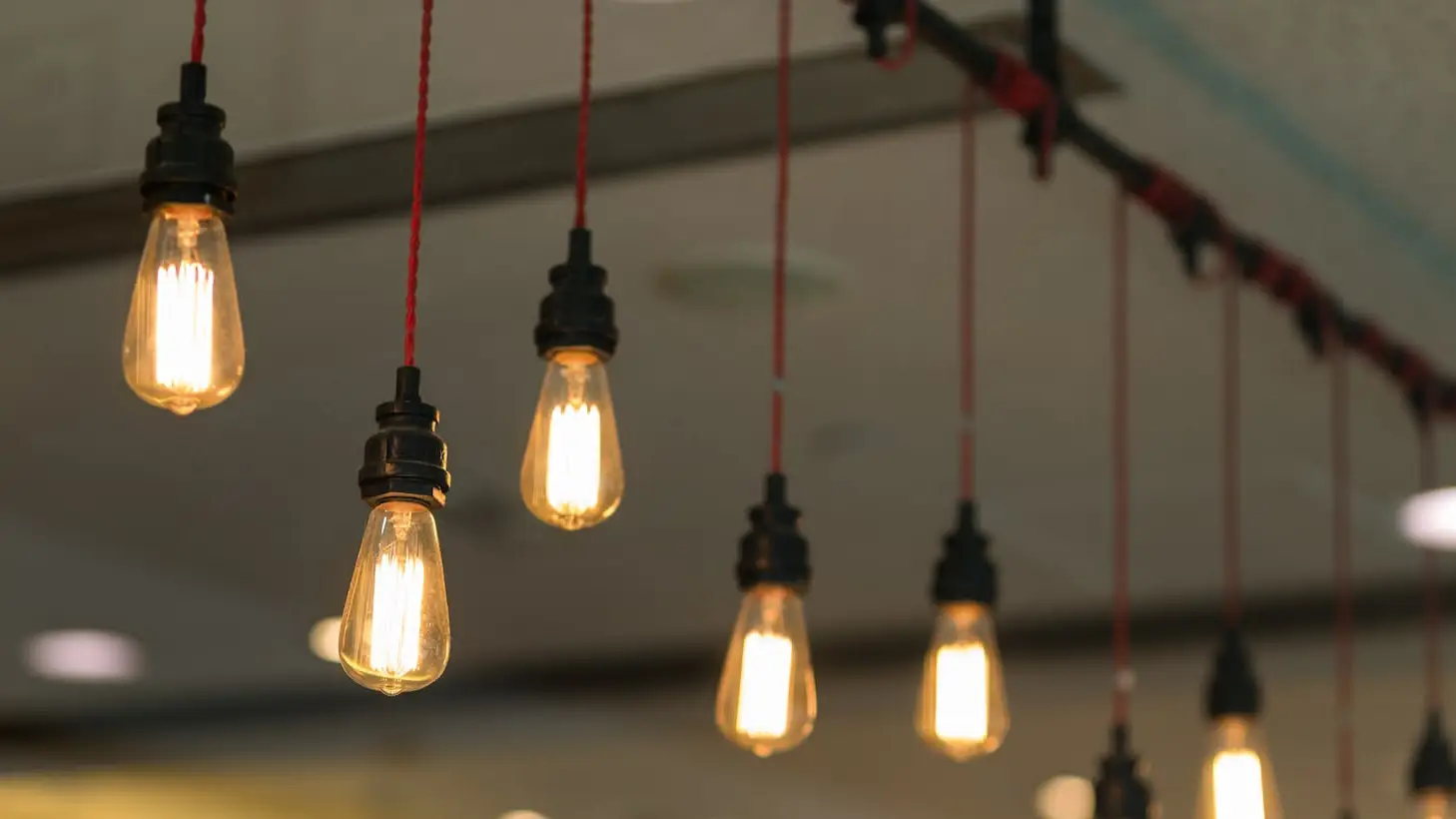 Hanging vintage light bulbs glowing warmly
