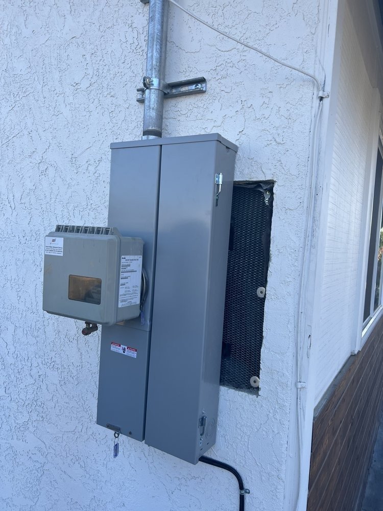 Outdoor electrical meter and breaker panel on wall